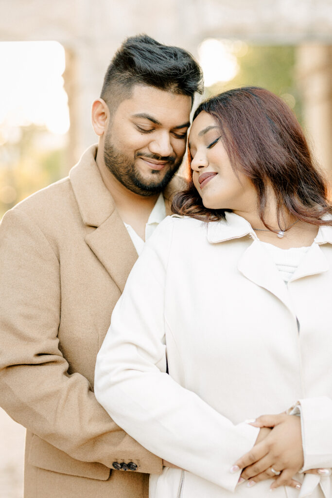 Romantic close-up of a couple embracing in soft golden light with natural connection in Winnipeg