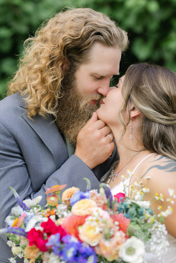 bride and groom smiling closely during romantic natural wedding photos