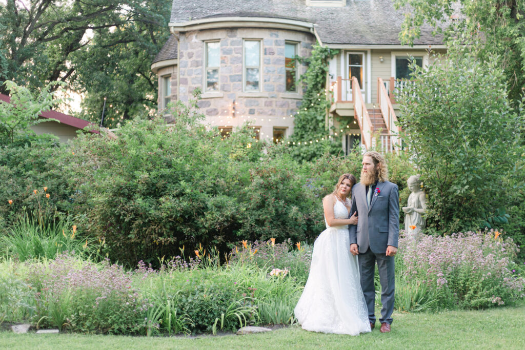Bride and groom in gardens at Bella’s Castle wedding in Morden Manitoba